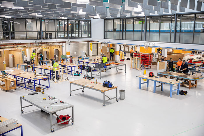 Photograph of students working in a large open plan carpentry workshop 