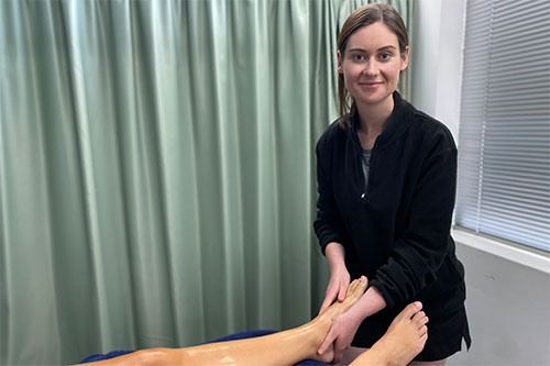 Student demonstrating proper massage therapy