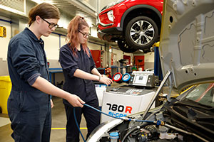 two female students doing workshop activity in automotive industry